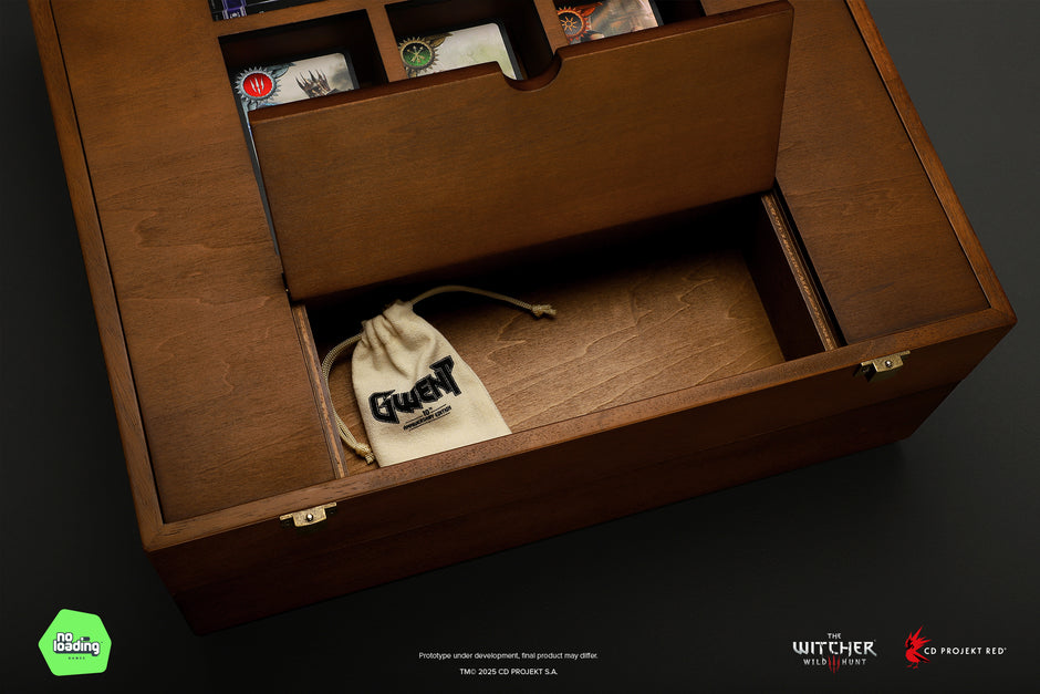 Wooden box with compartments and a drawstring bag inside, on a dark background.